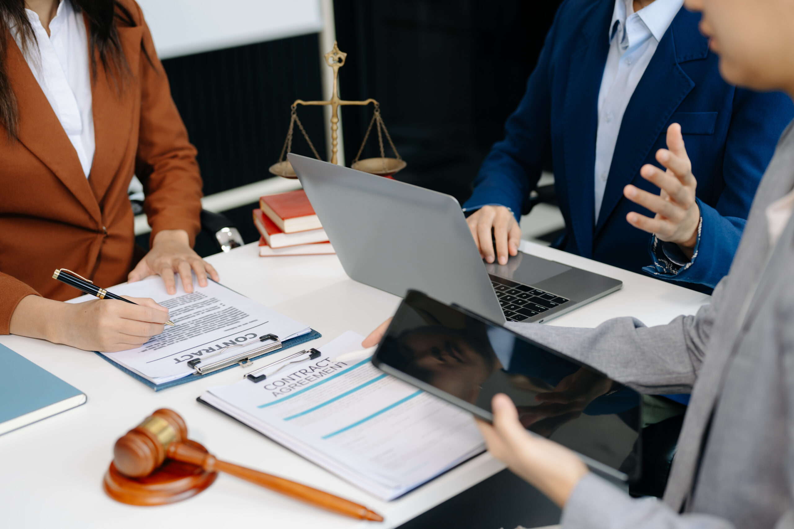 business people and lawyers discussing contract papers sitting at the table. Concepts of law, advice, legal services. in morning light