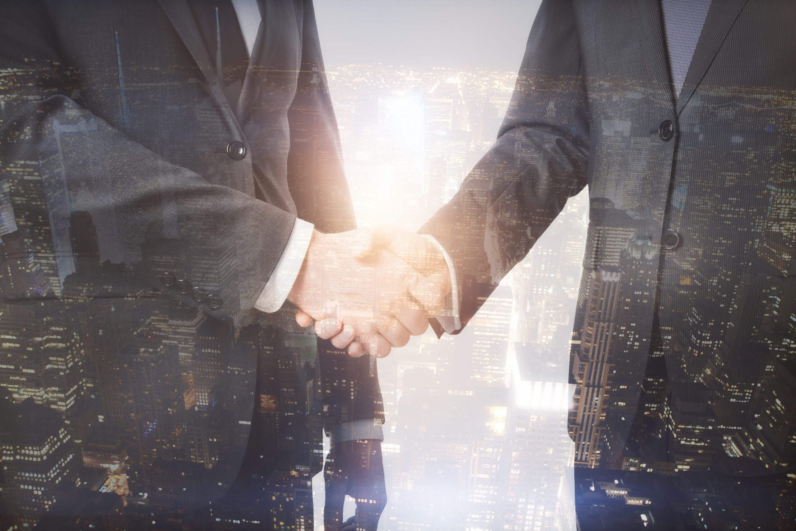 young-businessmen-shaking-hands-on-abstract-city-b-2026-01-11-08-48-23-utc